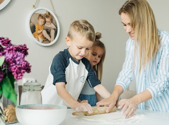 Mother and children enjoying a fun and messy baking session together at home.